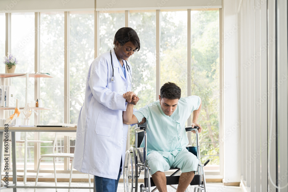 Nurse caring male patient with carefully trying walking from wheelchair at hospital. Female assistant taking care male patient from wheelchair. Healthcare and medical concept