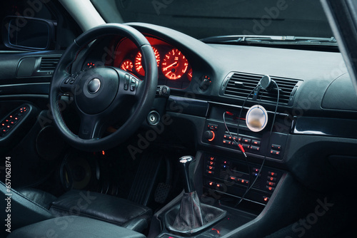 black car interior with leather seats and red backlight at night photographed on long exposure © yurii oliinyk