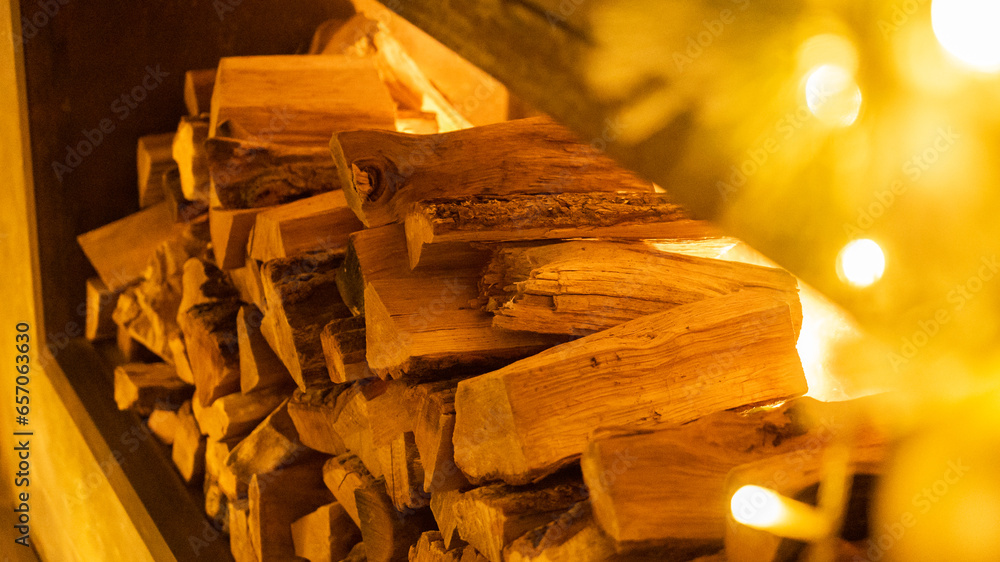 Αυτοκόλλητο Firewood heap of natural timber in semi-dark room closeup