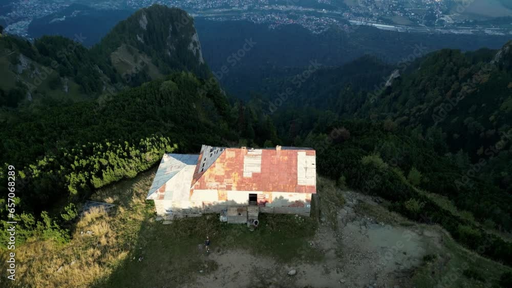 Drone flying over casa Cantonul Jepi. Bucegi Natural Park. Capturing Carpathian majesty. Aerial views of green rocky slopes in the Bucegi Mountains, Romania Drone flying over casa Cantonul Jepi. Bucegi Natural Park. Capturing Carpathian majesty. Aerial views of green rocky slopes in the Bucegi Mountains, Romania
