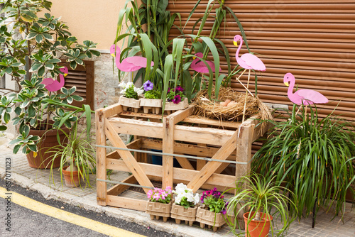 Wooden box, decorated with some pink flamingos and flower pots on 