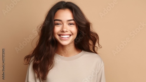 A charming young girl displaying her cheerful personality against a soft, pastel studio backdrop.