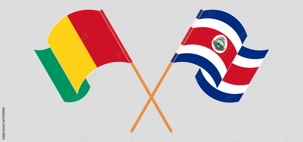 Crossed and waving flags of Guinea and Costa Rica Crossed and waving flags of Guinea and Costa Rica