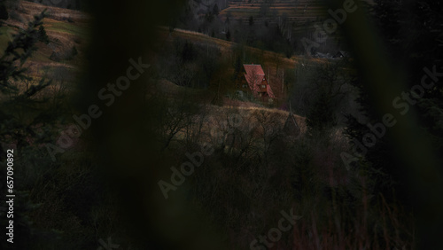 dark mist country side hills landscape with lonely mansion house photography dark blurred foreground frame spooky place October autumn nature environment