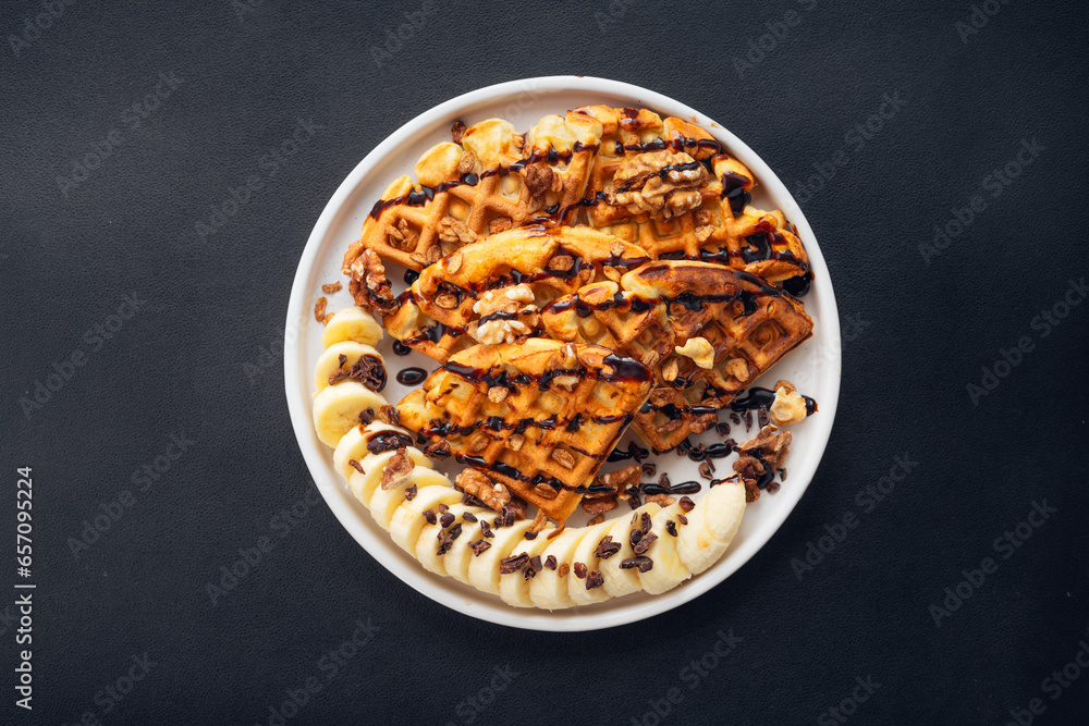 Waffle, banana, chocolate topped with walnuts Waffle, banana, chocolate topped with walnuts