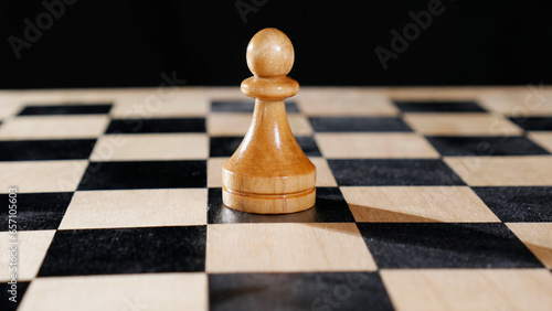 A lone pawn on a chessboard. Close-up