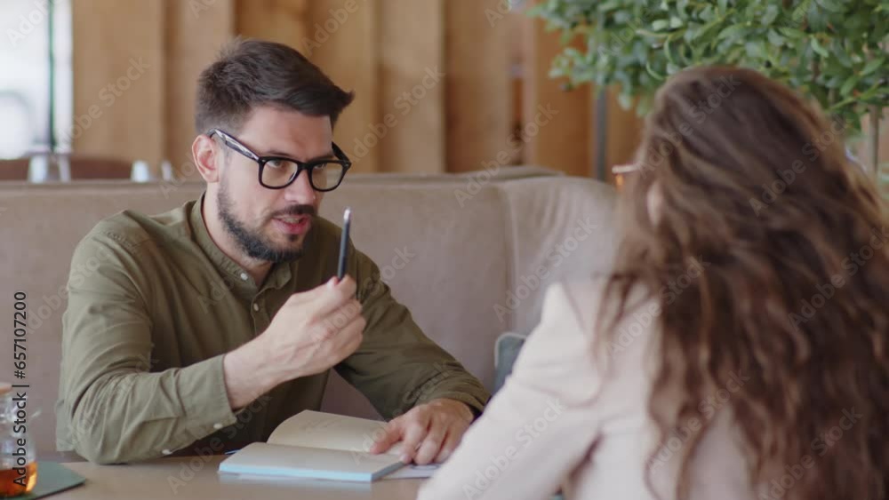 Man sharing strategy of company development with his female co-worker Man sharing strategy of company development with his female co-worker