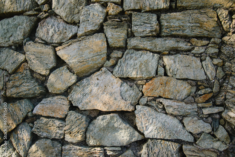 stone wall background. The texture of the pavement lined with natural stone on an old street in Europe