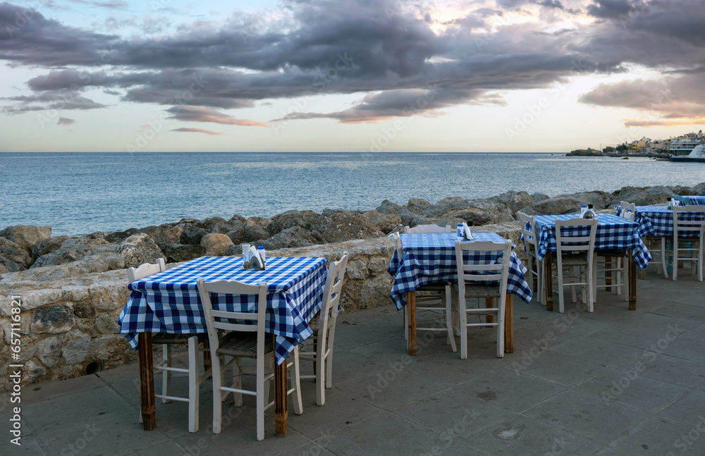 Empty beach tavern restaurant at Paleochora town, Crete island Greece. Rocky landscape, sea, sky.