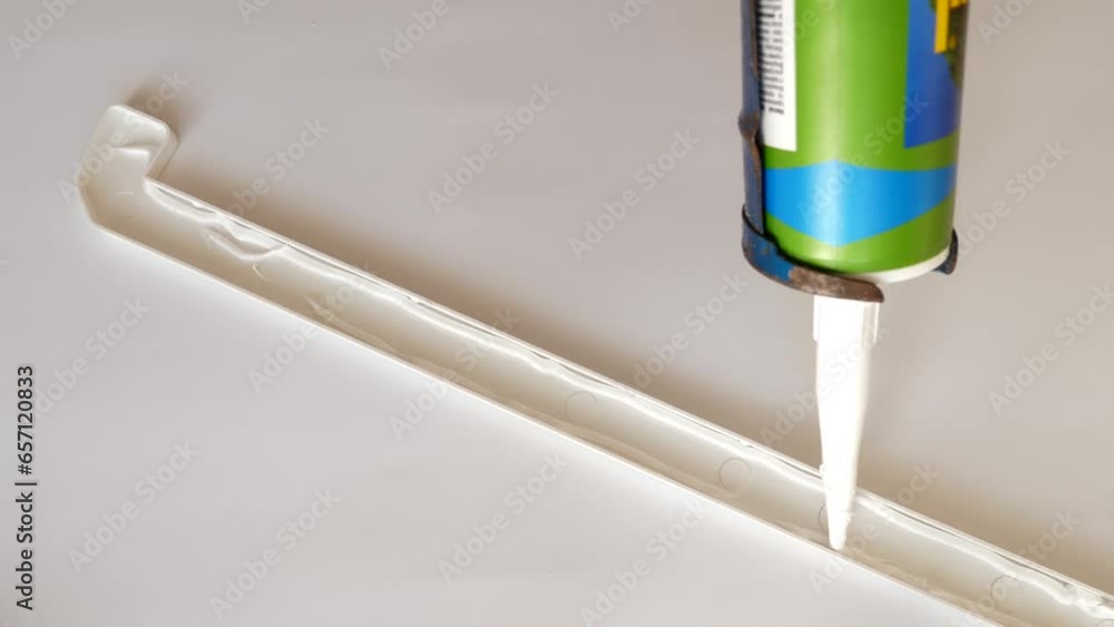 Silicone is applied to the window sill cap for installation. Construction works. Installing a