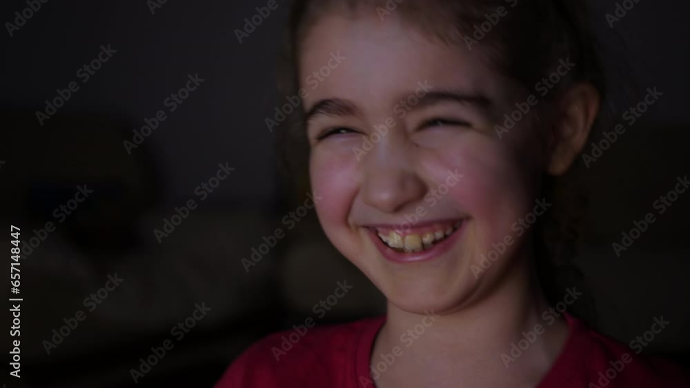 Child Watching TV, Close up Face of Little Girl, Kid Eyes. Portrait Laughing Kid While Watching TV. Girl Watch Television on Living Room. Concept Video Game, Entertainment, Emotions, Streaming Tv. Child Watching TV, Close up Face of Little Girl, Kid Eyes. Portrait Laughing Kid While Watching TV. Girl Watch Television on Living Room. Concept Video Game, Entertainment, Emotions, Streaming Tv.
