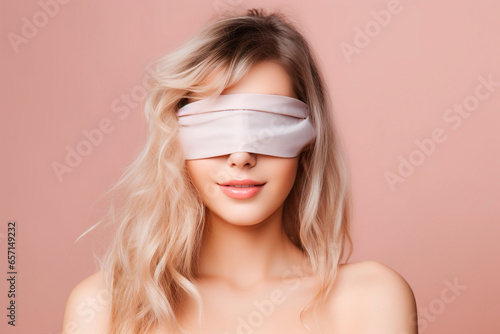 a young woman with a blindfold that prevents her from seeing. Studio photo with pastel background. bright background, soft shadows