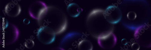 Abstract background with neon bubbles, iridescent colorful glass balls or spheres on a black background.