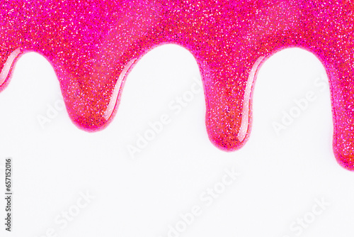 Pink glitter sparkle confetti background liquid drops of paint color flow down on white canvas. Dark pink glitter paint dripping on the white wall.