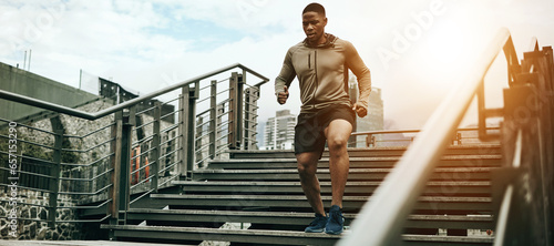 Fitness, city and black man running on steps outdoor, exercise and training healthy body in the morning. Sports, cardio and African athlete on stairs for endurance workout, energy or jog for wellness