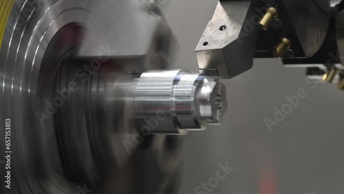 The  CNC lathe machine forming  cutting the metal shaft parts.