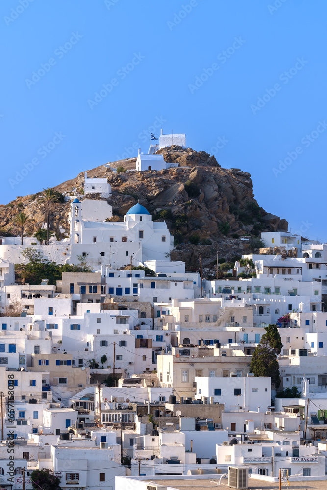 Panoramic view of the picturesque and whitewashed island of Ios Greece and a blue sky in the background