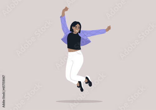 A joyful young woman in a quilted jacket adorned with wave patterns, jumping with her arms raised high above her head