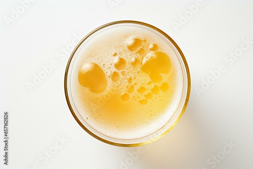 Overhead view of a pale beer glass against a white background, showcasing fine details. The beer is a lager, specifically pils or pilsner. Generative AI