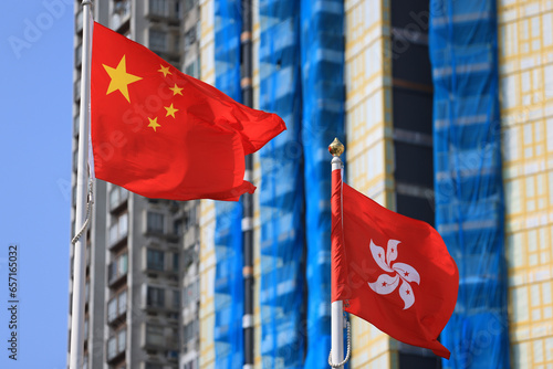 Chinese and hong kong flag set up in the event for celebrating the National Day of the People's Republic of China 74 th anniversary with the real estate background photo