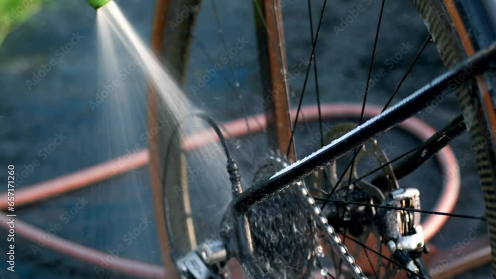 Cleaning bicycle rear derailleur close up video. Washing gravel bicycle