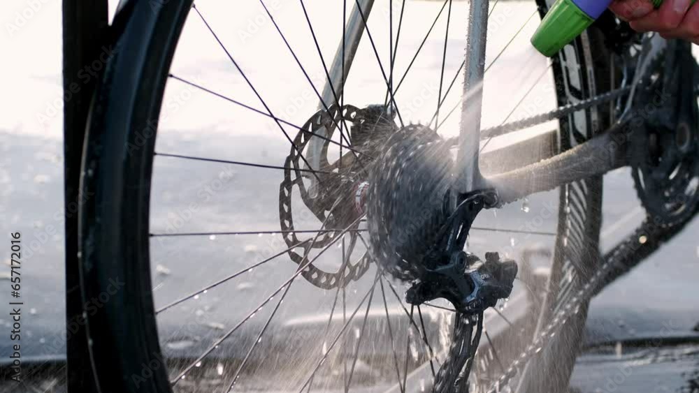 Cleaning bicycle rear derailleur close up video. Washing gravel bicycle