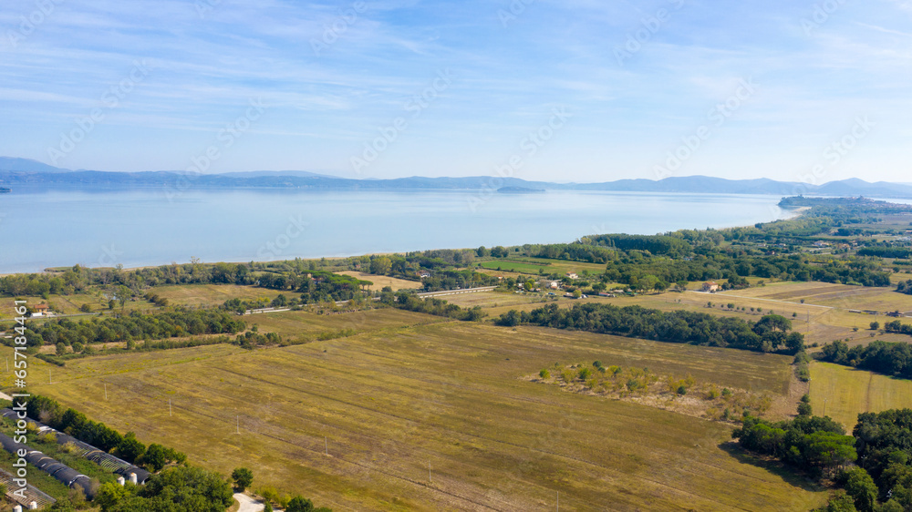 Aerial view of Lake Trasimeno. Lake Thrasimene is located in the province of Perugia, in the Umbria region of Italy on the border with Tuscany. Around there are cultivated fields.