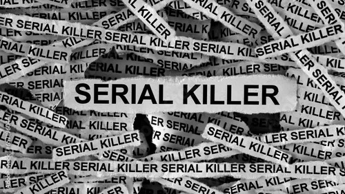 Strips of newspaper with the words Serial Killer typed on them. Black and white. Close up. photo