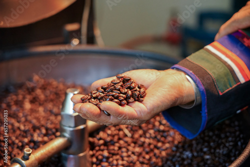 Coffee roasting process and roasted coffee in hand.