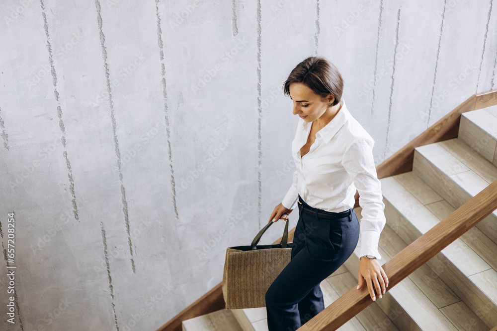 Business woman walking the hotel stairs to her room Business woman walking the hotel stairs to her room