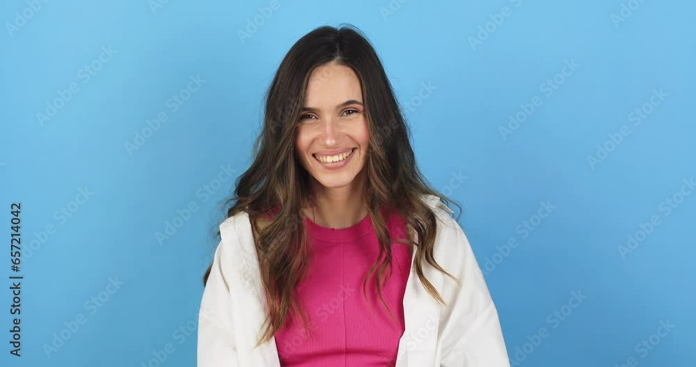 Amazed excited woman hairstyle in white shirt, pink top open mouth in surprise looking at camera with big eyes, shocked. Indoor studio shot isolated on blue background. Oh my god wow, yes gesture. Amazed excited woman hairstyle in white shirt, pink top open mouth in surprise looking at camera with big eyes, shocked. Indoor studio shot isolated on blue background. Oh my god wow, yes gesture.
