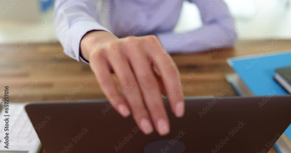Office worker opens laptop to work on business project. Female in blouse entering information to business meeting in company Office worker opens laptop to work on business project. Female in blouse entering information to business meeting in company