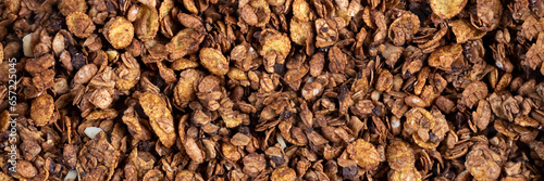 Organic roasted granola cereal banner. Top view muesli background texture panoramic web header. Wide screen wallpaper