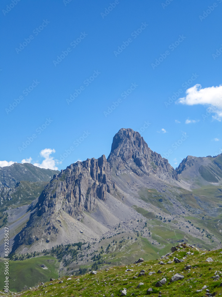 Naklejka premium Scenic mtb trail with view of Rocca La Meja near rifugio della Gardetta on the Italy French border in Maira valley in the Cottian Alps, Piedmont, Italy, Europe. Hiking on sunny summer day in mountains
