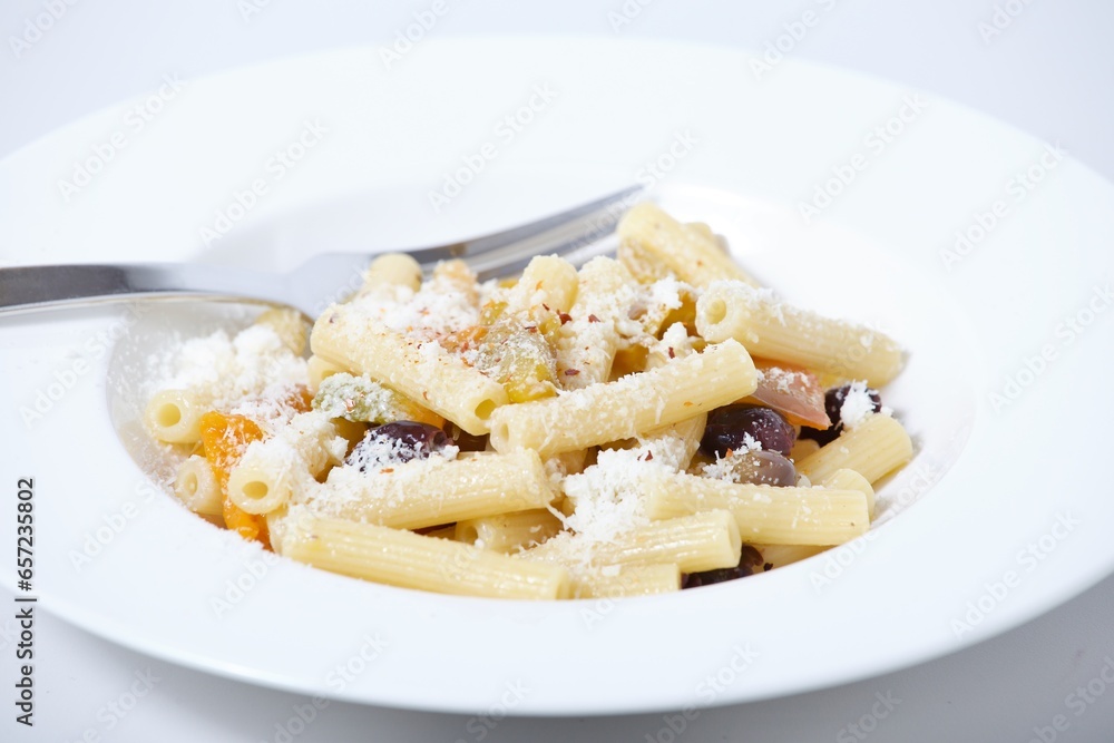 Plate of pasta with pepper and olives Plate of pasta with pepper and olives