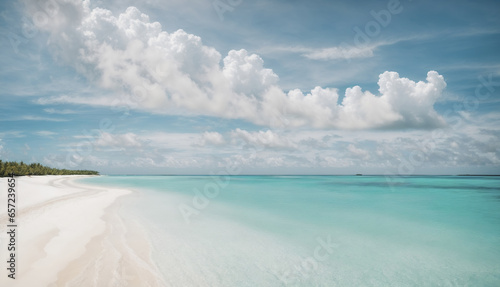 Beach featuring pristine white sands, a calm turquoise ocean, and a sunlit sky of fluffy clouds