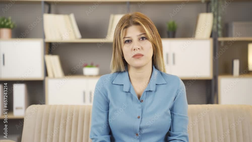 Portrait of woman sitting on sofa at home. Portrait of woman sitting on sofa at home.