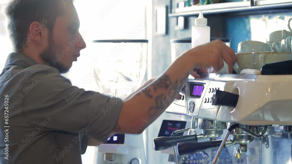 Handsome male barista preparing espresso Handsome male barista preparing espresso
