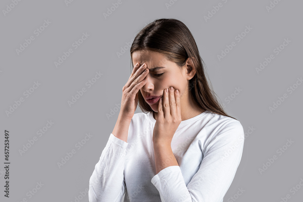 Girl suffering from toothache, tooth decay or sensitivity. Toothache, Woman with Tooth Infection. Woman suffering from toothache against gray background. Young woman suffering from toothache Girl suffering from toothache, tooth decay or sensitivity. Toothache, Woman with Tooth Infection. Woman suffering from toothache against gray background. Young woman suffering from toothache