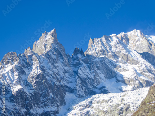 Snow capped Mont Blanc mountain range massif in Alps seen from lift station Pointe Helbronner (Punta Helbronner) in Courmayeur, Aosta Valley, Italy, Europe. Graian Alps on watershed France and Italy