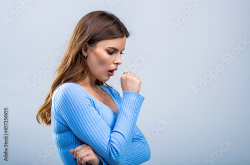 Woman is suffering with cough and feeling bad. Ill woman. Sick young girl coughing covering mouth with hand keeping. Healthy lifestyle ill sick disease treatment cold season concept. Girl coughs