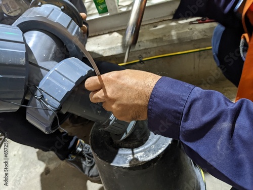 Welding PVC material for rectify leakage on PVC pipe line. The photo is suitable to use for industrial background and safety content media.