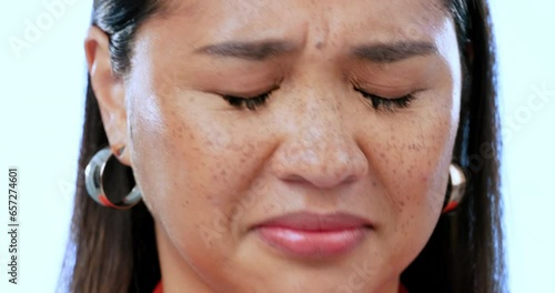 Bad smell, woman and holding nose for sweat, smelly fragrance, scent or gas in studio on blue background. Asian, portrait and person with hand on face for bad perfume or yuck reaction to body odor