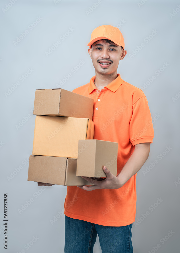 Handsome delivery man holding parcel boxes. Handsome delivery man holding parcel boxes.