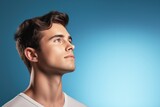 Portrait of young man. Skin care beauty, skincare cosmetics. Isolated over blue background. Copy Space.