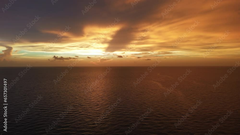 Burning sky and shining golden waves. Ocean beach sunsets. Aerial wide footage Burning sky and shining golden waves. Ocean beach sunsets. Aerial wide footage