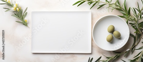 Vertical wedding table setting with olive branch decor and blank card showcasing a modern and elegant Mediterranean theme Copy space available With copyspace for text