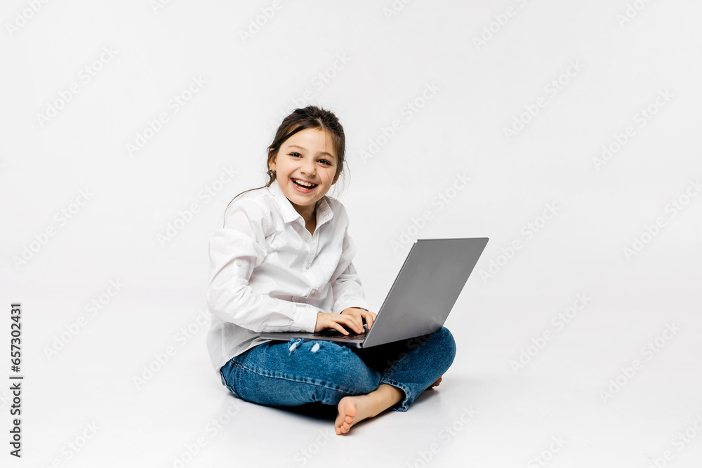 Schoolgirl typing on keyboard using laptop with touch screen, online course of educational lessons at home. Distance learning, distance video conferencing. Schoolgirl studying at school Schoolgirl typing on keyboard using laptop with touch screen, online course of educational lessons at home. Distance learning, distance video conferencing. Schoolgirl studying at school