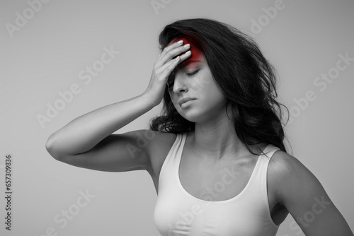 Monochrome photo of woman suffering from headache photo