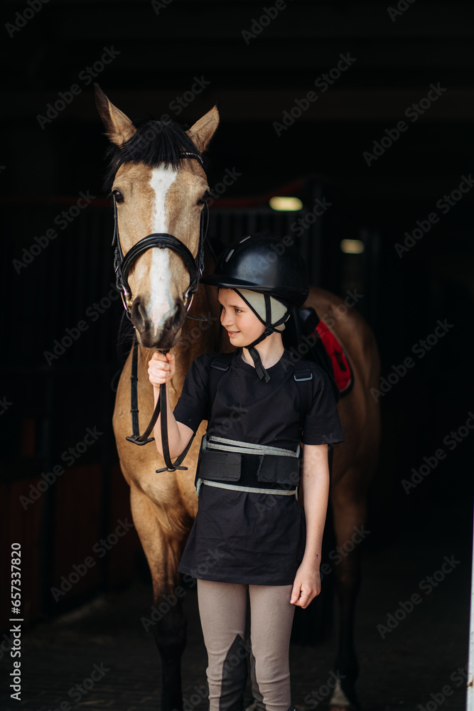 Portrait of a young jockey with a horse, horse riding training, a boy